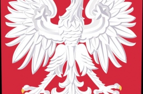 Biały orzeł z rozpostartymi skrzydłami, złotą koroną na głowie, złotym dziobem i szponami, umieszczony na czerwonym tle w kształcie tarczy. 