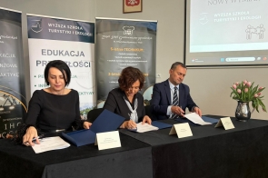 Trzy osoby siedzą przy stole, od lewej: Kornelia Zubek Dyrektor ZSGH w Wiśle,  Janina Żagan Starosta Cieszyński oraz dr hab.Marek Nocoń Dziekan Wydziału Nauk Społecznych, podpisują dokumenty. Za nimi stoją roll-upy z informacjami o szkołach, na ścianie godło Polski i ekran.