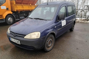 Opel Combo z oznaczeniem Powiatowego Zarządu Dróg Publicznych w Cieszynie, zaparkowany na mokrej nawierzchni obok pojazdu ciężarowego.