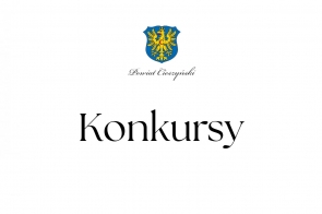 Czarny napis na białym tle: "Konkursy", powyżej herb Powiatu Cieszyńskiego.