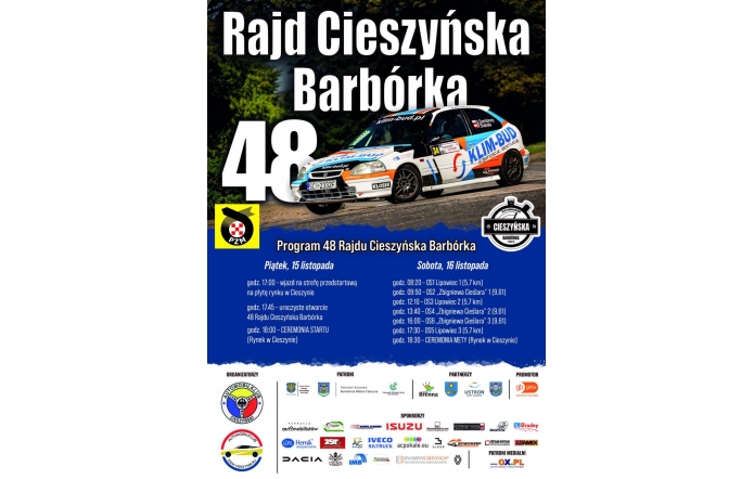 Plakat 48. Rajdu Cieszyńska Barbórka z dużym zdjęciem samochodu rajdowego na trasie. U góry widoczna jest nazwa wydarzenia, a poniżej szczegółowy program rajdu na 15 i 16 listopada. Grafika utrzymana jest głównie w czarnej, białej i niebieskiej kolorystyce, a na dole umieszczono logotypy.